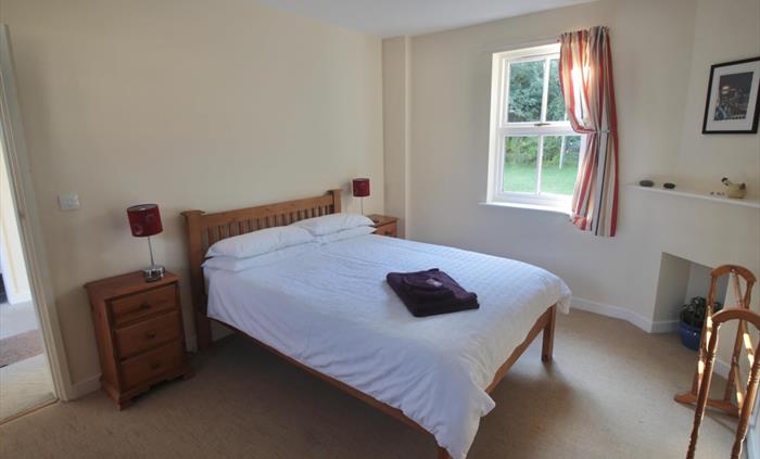 Spacious bedroom with tranquil garden views